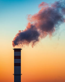 Low angle view of lighthouse against sky during sunset