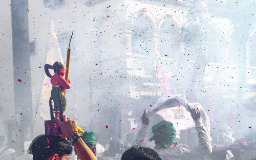 People celebrating traditional festival on street in city