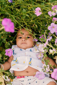 High angle view of cute baby girl sitting on grass