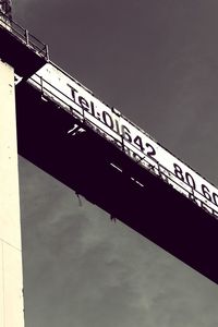 Low angle view of information sign against sky