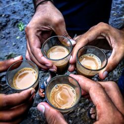 Midsection of man holding coffee cup