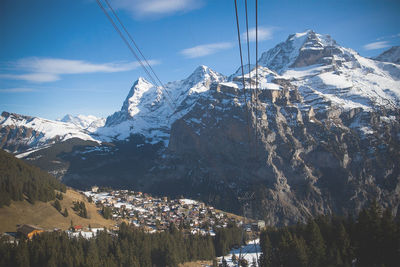 Scenic view of snow covered mountains against sky