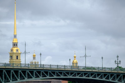 Bridge over river amidst buildings against sky