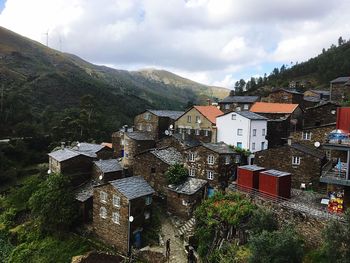 High angle view of houses and trees against sky