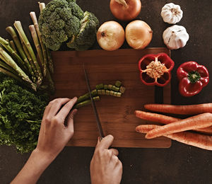 Cropped hands of person preparing food on table