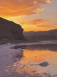 Scenic view of sea against orange sky