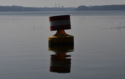 Lifeguard hut on lake against sky