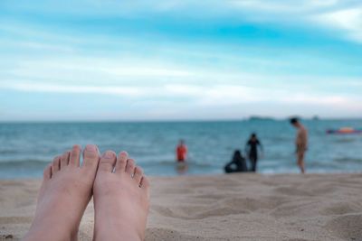 People on beach against sky