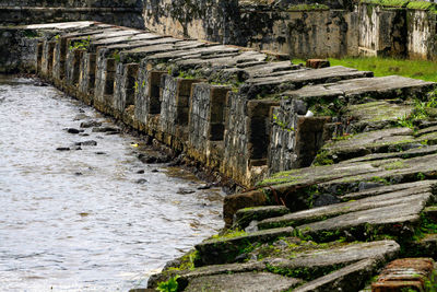 View of stone wall over ocean 