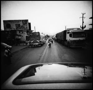 Cars on street against clear sky