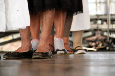 Low section of women wearing shoes standing on floor