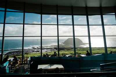 Group of people in restaurant by sea