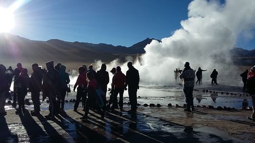 People by hot spring during sunny day