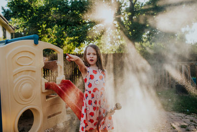 Smiling girl standing against blurred background