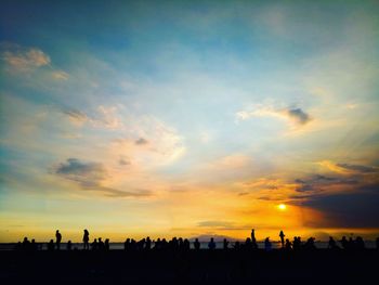 Silhouette cityscape against sky during sunset