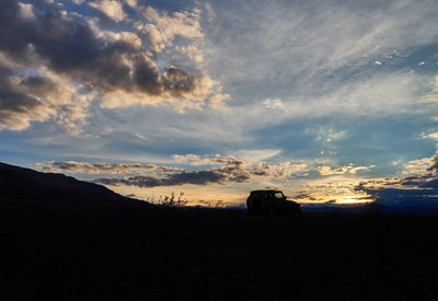 Silhouette landscape against sky during sunset