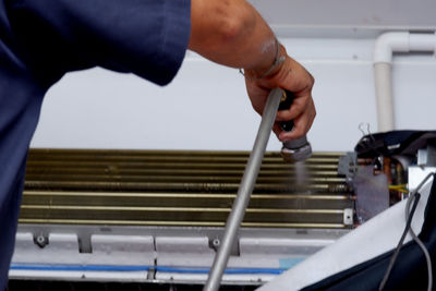 Close-up of man working on metal