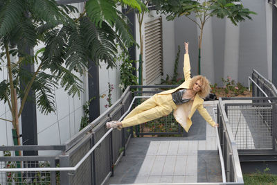 Urban style street fashion photosoot young model wearing yellow trendy suit