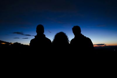 Silhouette landscape against sky at dusk