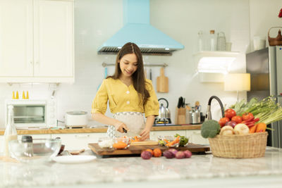 Young woman preparing food at home