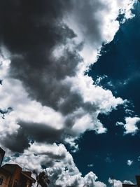 Low angle view of building against cloudy sky