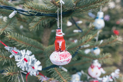 Painted red and white old electric light bulb on christmas tree. diy decoration