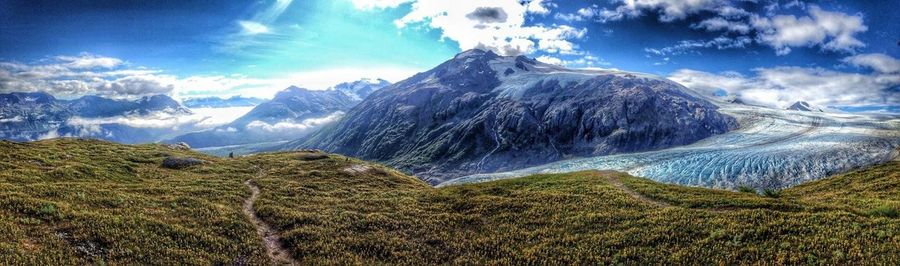 Scenic view of mountains against cloudy sky