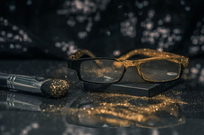 Close-up of sunglasses on glass table