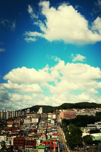 View of residential district against cloudy sky