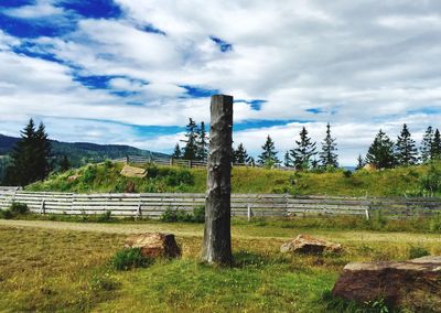 Fence on field against sky