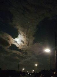 Low angle view of illuminated street light against sky