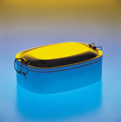 Close up of metallic lunch box on blue background