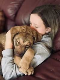 High angle view of teenager with dog at home