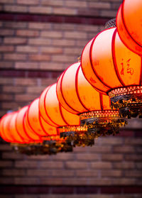 Low angle view of illuminated cross against wall