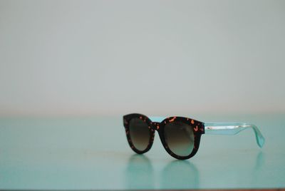 Close-up of sunglasses on glass table