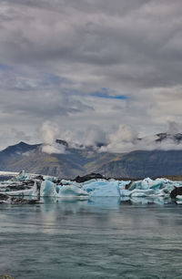 Scenic view of lake against sky during winter