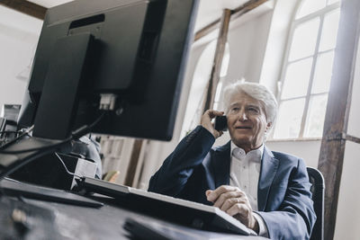 Senior businessman on the phone in his office