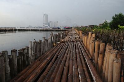 Pier over river against sky