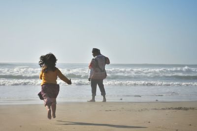 Full length of woman on beach against sky