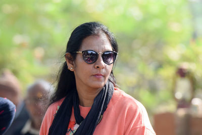 Portrait of young woman wearing sunglasses standing outdoors