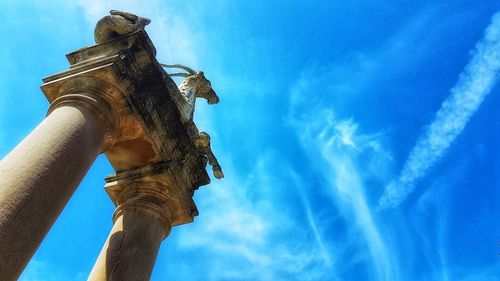 Low angle view of statue against blue sky