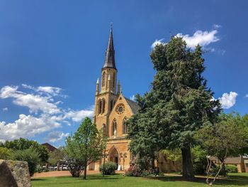 Trees and historic building against sky