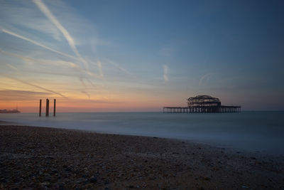 Scenic view of beach against sky during sunset