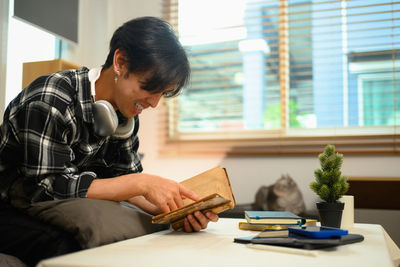 Young man using laptop while sitting at home
