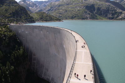 High angle view of people on mountain by sea