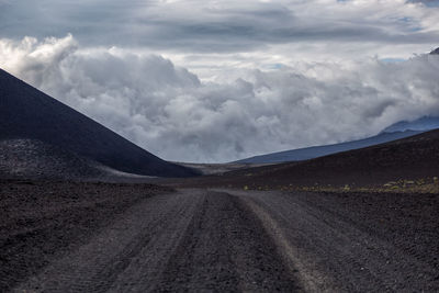 Road amidst desert against sky