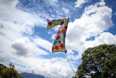 Low angle view of flag against cloudy sky