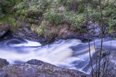 Scenic view of river flowing through rocks in forest. part of skinnarsågsfallet, kilsbergen.