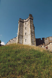 Low angle view of built structure against clear blue sky