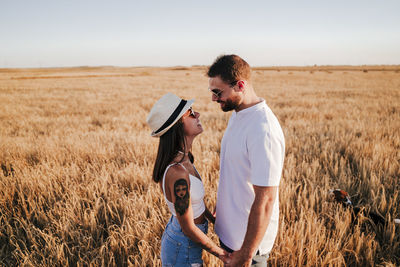 Young couple standing in field